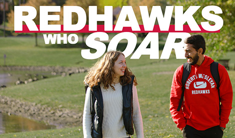 2 students talk on campus. Redhawks Who Soar