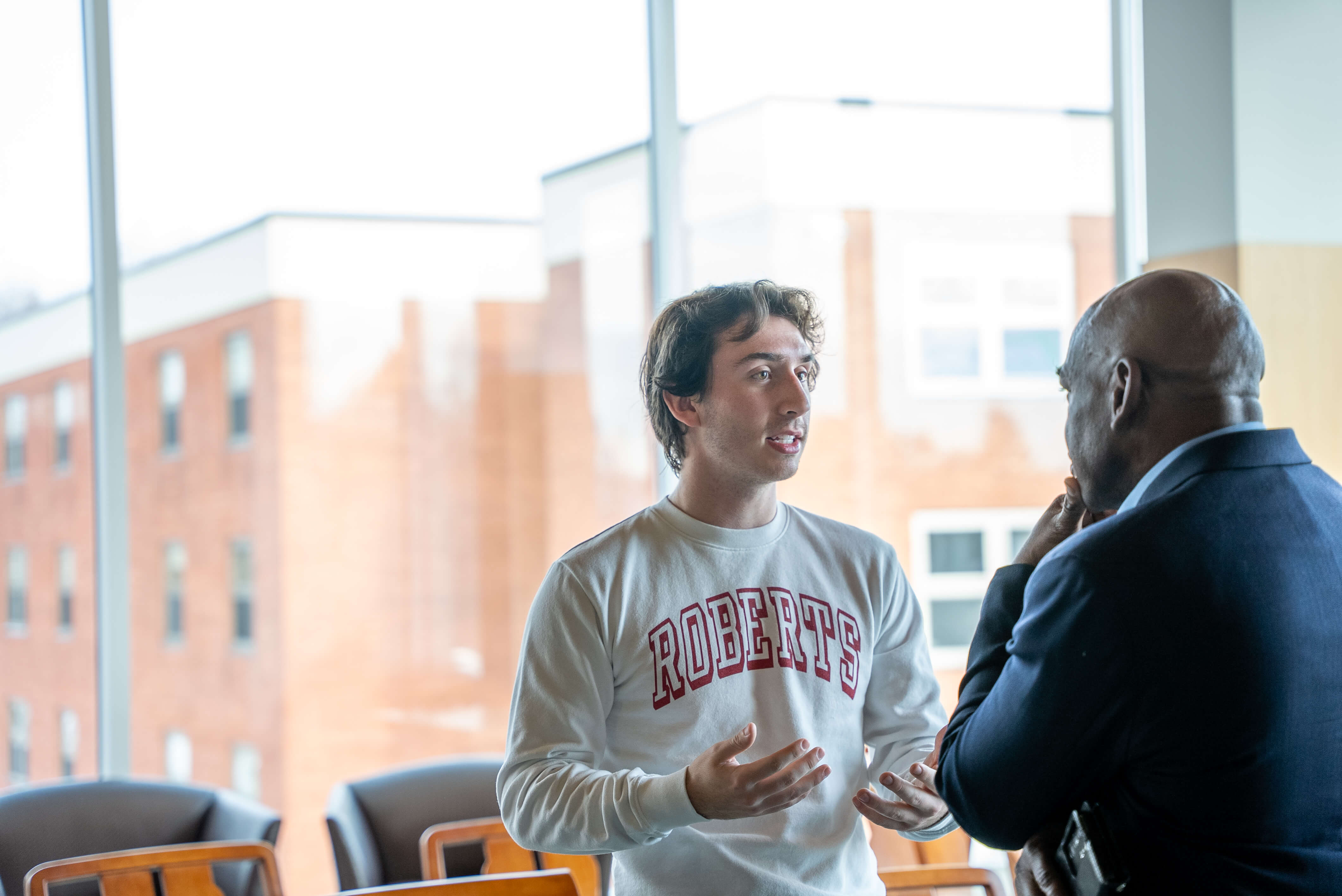 a male student speaking with Rupert Hayles