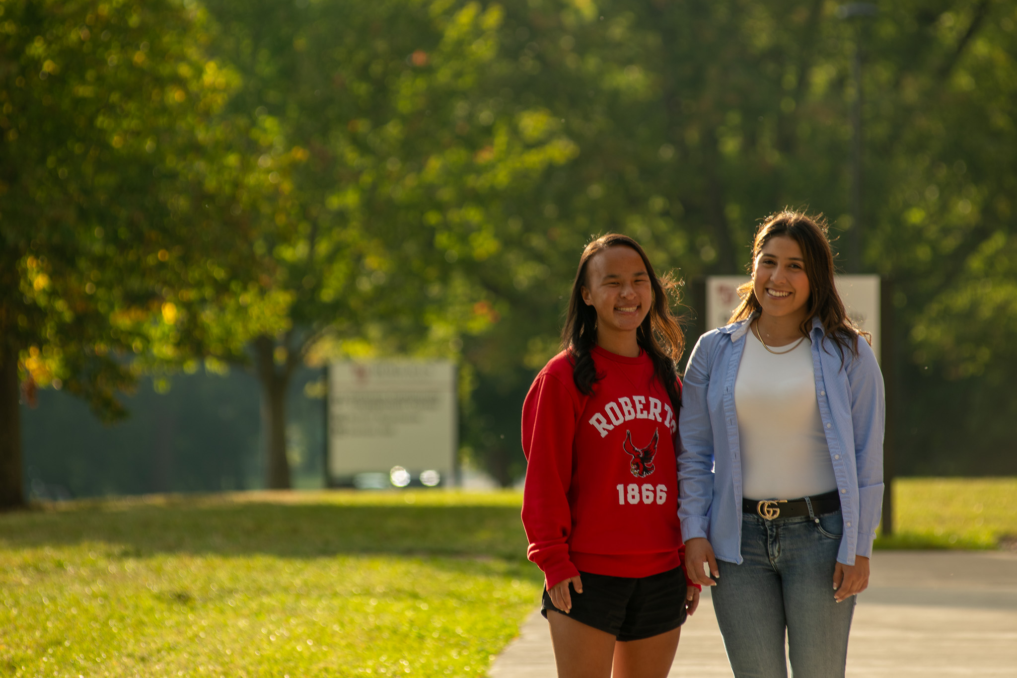 Two students smile on campus