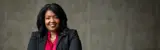 A confident business student smiles