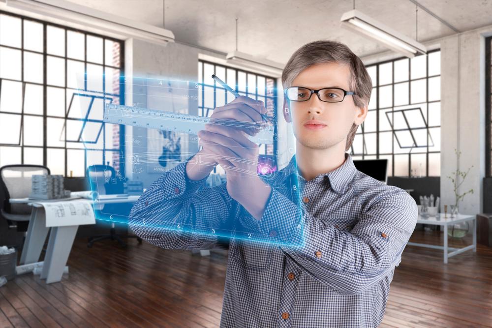 A young man works on a digital screen